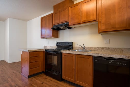 a kitchen with wooden cabinets and black appliances and a counter top