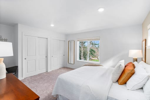 a bedroom with a bed and a window