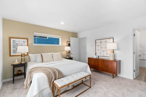 a master bedroom with a bed and a dresser