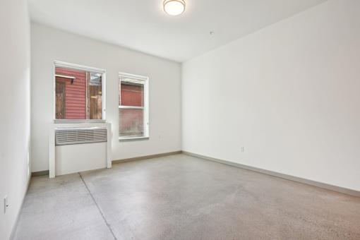 Empty room with a window and a radiator.