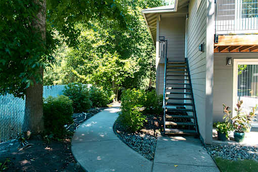 A house with a staircase leading to the front door.