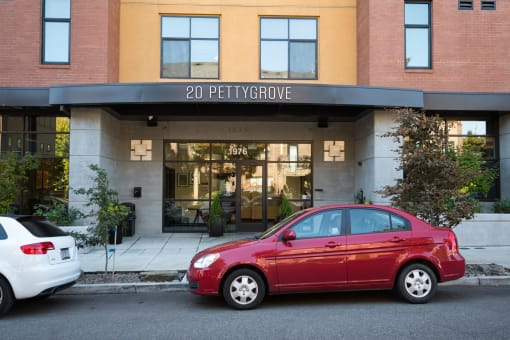 a red car parked in front of a building