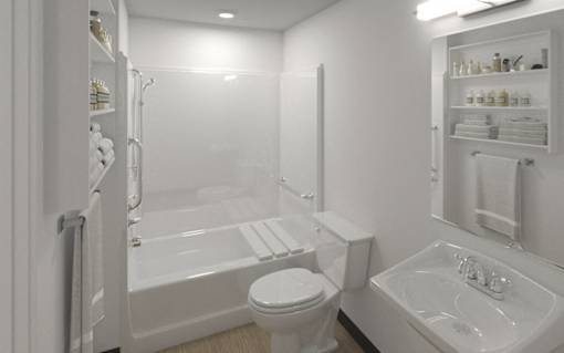 A white bathroom with a toilet, sink, and bathtub.