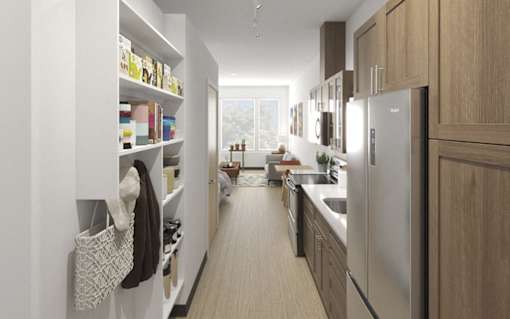 A modern kitchen with a refrigerator, sink, and cabinets.