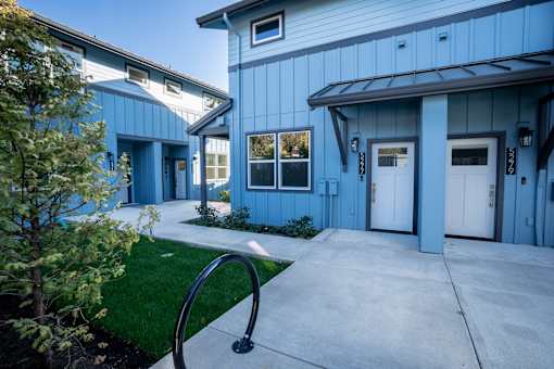 A blue building with white doors and windows.