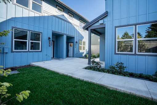 A blue building with a white door and windows.