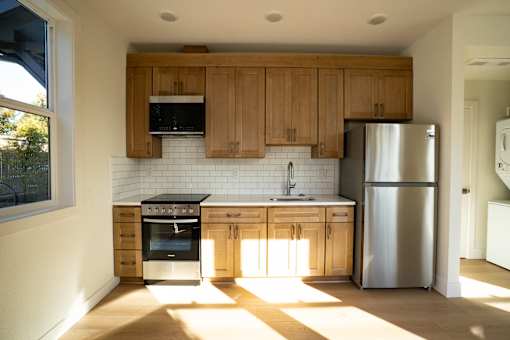 A kitchen with wooden cabinets and stainless steel appliances.