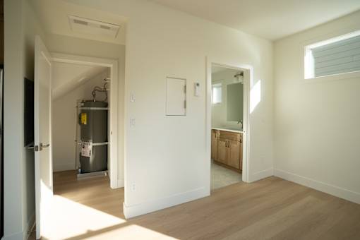 A room with a white door and a white wall.