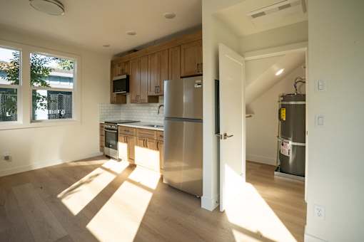 A kitchen with wooden cabinets and a white refrigerator.
