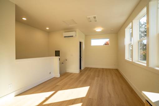 A room with wooden floors and a window.