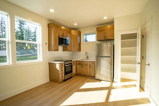 A modern kitchen with wooden cabinets and stainless steel appliances.