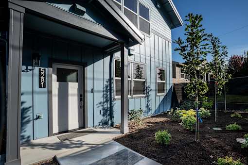 A blue building with a white door and windows.