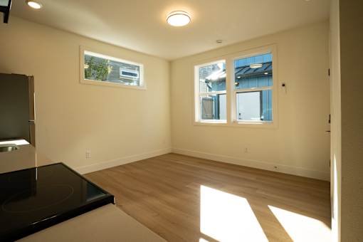 A sunny room with a black countertop and a window.