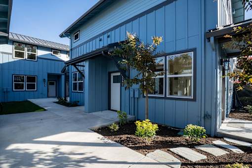 A blue building with a white door and windows.