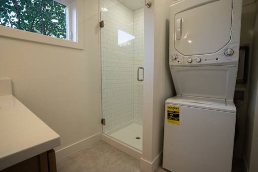 A bathroom with a toilet, sink, and shower.