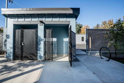 A blue building with a black gate and a white door.