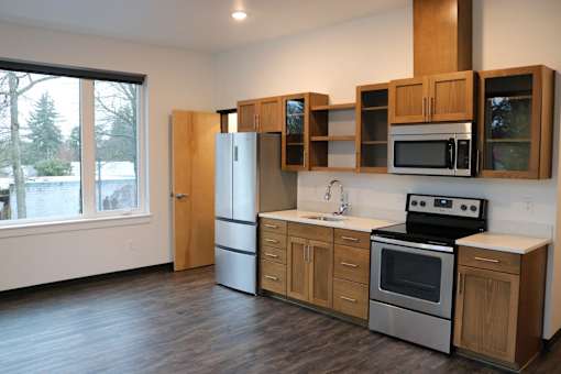 A kitchen with wooden cabinets and stainless steel appliances.