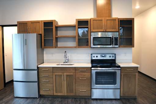 A modern kitchen with wooden cabinets and stainless steel appliances.