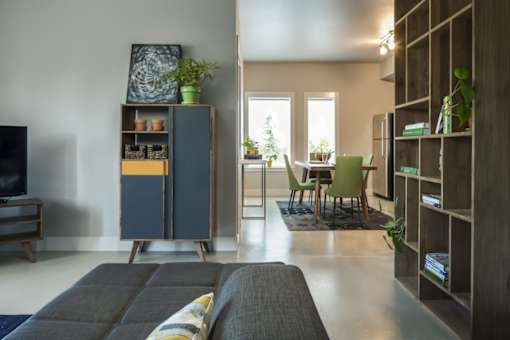 a living room with a couch and a dining room