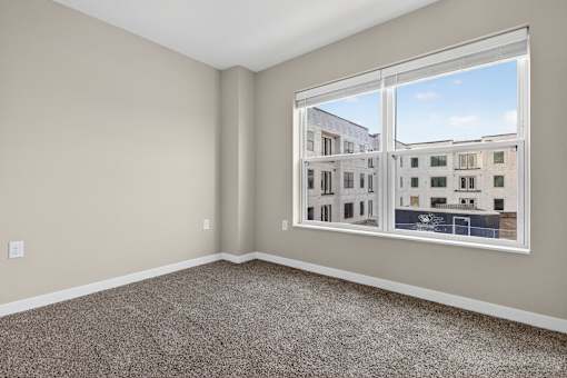 A room with a large window overlooking a building.