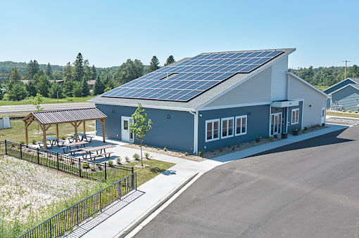 A modern building with solar panels on the roof.
