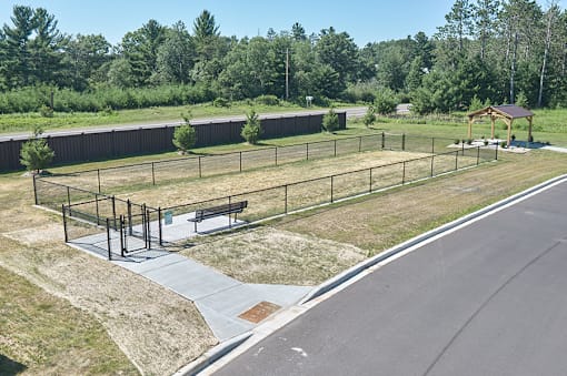 A park with a playground and a bench.