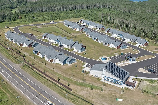 A bird's eye view of a residential area with houses and a roundabout.