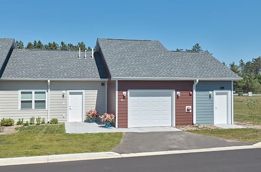 A house with a roof and a garage door.