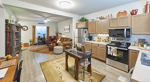 A kitchen with a refrigerator, oven, and microwave.