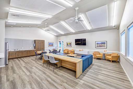 A conference room with a long table and chairs.