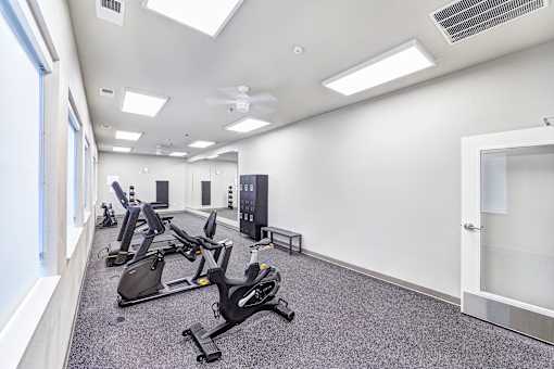 A gym with treadmills and elliptical machines.