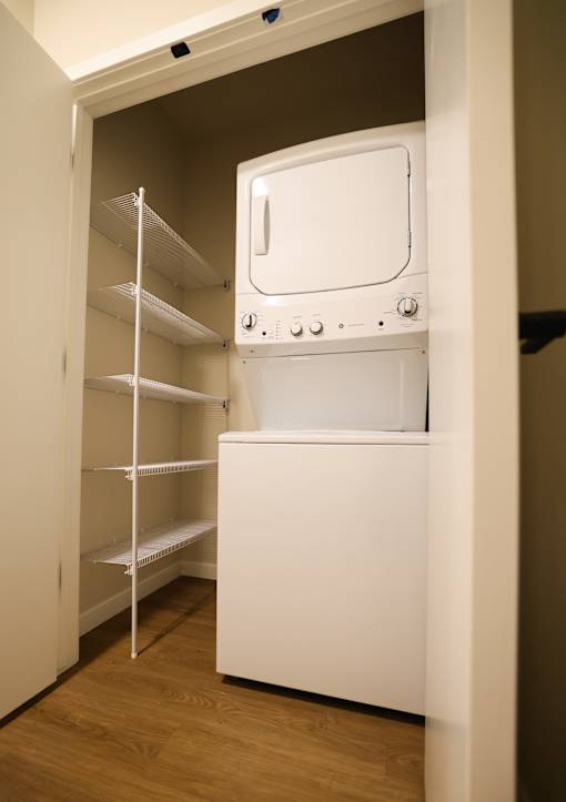 A white dishwasher is built into a wall in a kitchen.