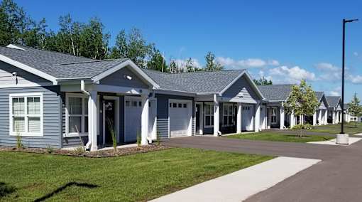 A row of houses with a clear blue sky above them.