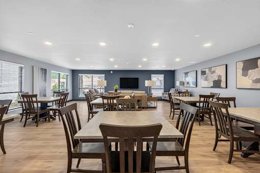 A large dining room with wooden chairs and tables.