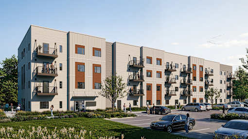 A modern apartment complex with cars parked in front.