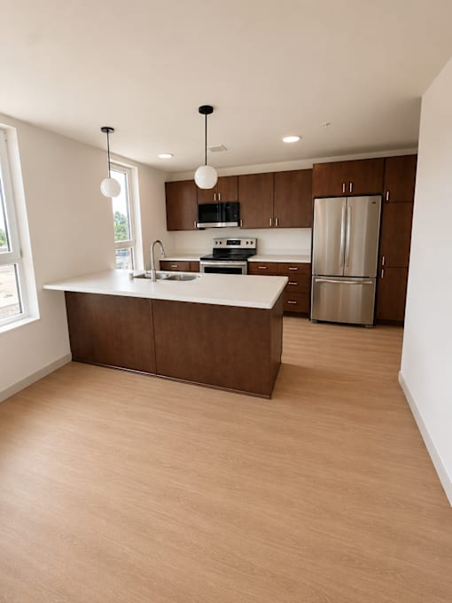 A kitchen with wooden cabinets and a countertop.