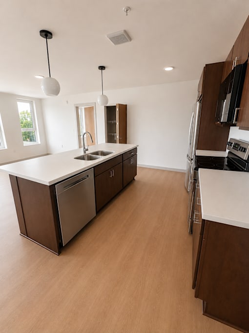 A modern kitchen with cabinets and countertops.