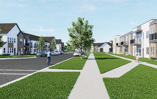 A street view of a residential area with houses on both sides and a person riding a bicycle at The Daniels at Northern Gateway Apartments, Saukville 53080