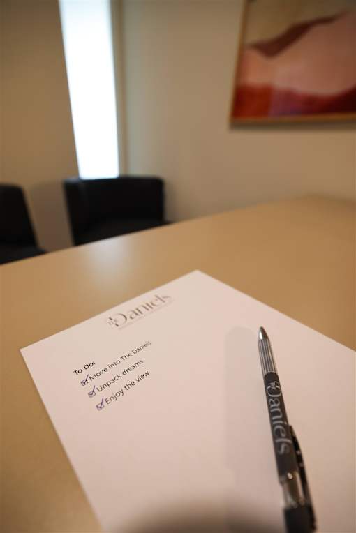 A to do list with a pen on a table.