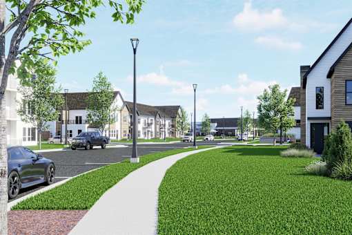 A street view of a residential area with houses and cars.