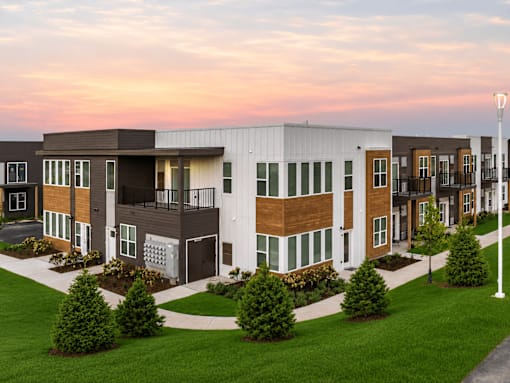 A modern apartment complex with a mix of brown and white exterior colors.