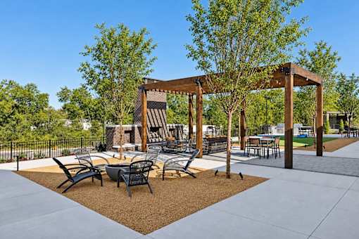 A park with a pavilion, chairs, and a table.