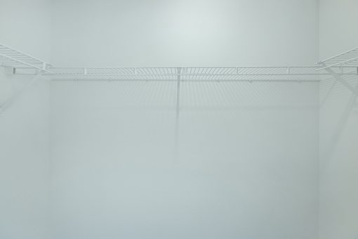 Empty white shelves in a room.
