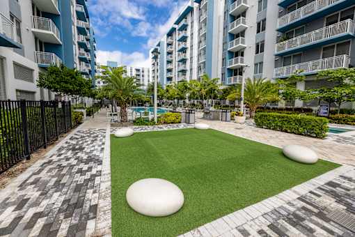 A grassy area with white spheres in the middle of it.
