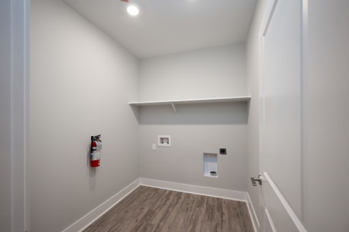 a small room with a fire extinguisher on the wall