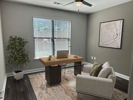 A room with a desk, chair, and potted plant.