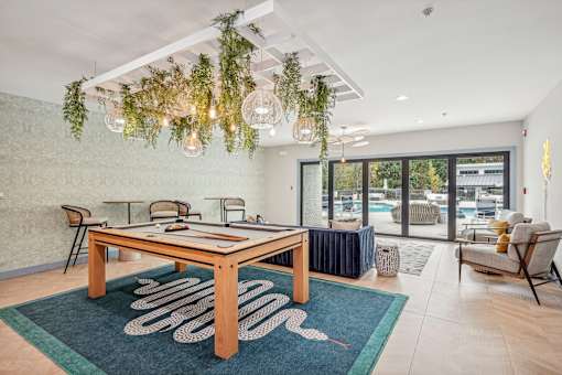 A modern dining room with a wooden table and chairs.