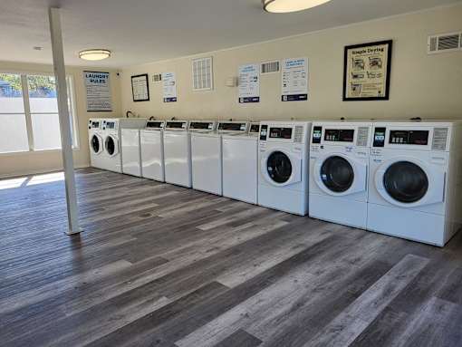 A laundromat with rows of washers and dryers.