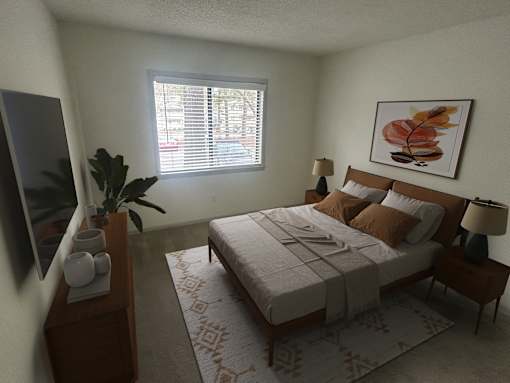 A bedroom with a bed, nightstand, and a plant.