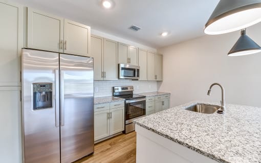a kitchen with stainless steel appliances and granite counter tops